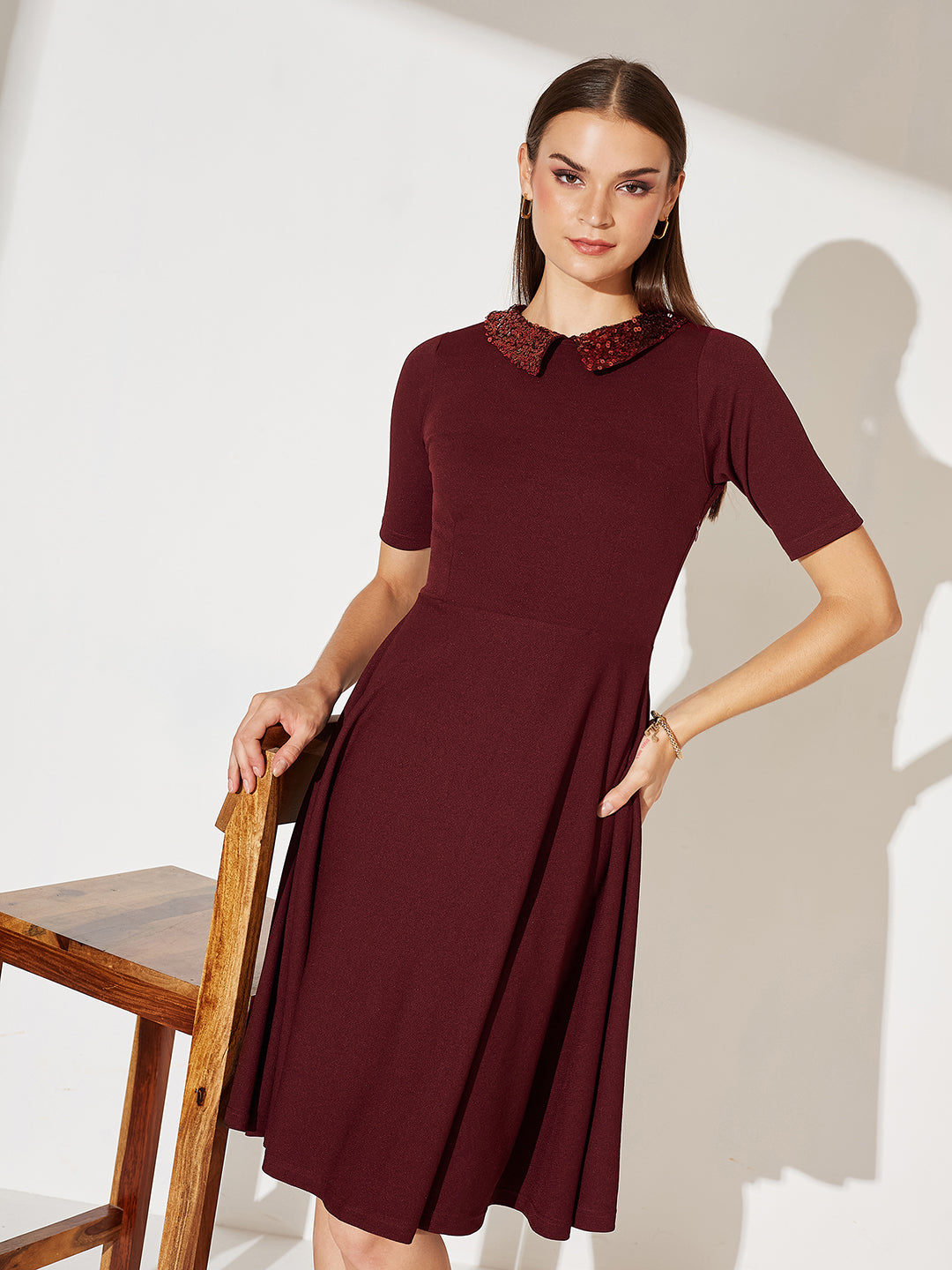 wine colored skater dress Women's Outfit: Burgundy Skater Dress, Multi colored Floral Canvas Pumps, Black Leather Clutch, Gold Bracelet