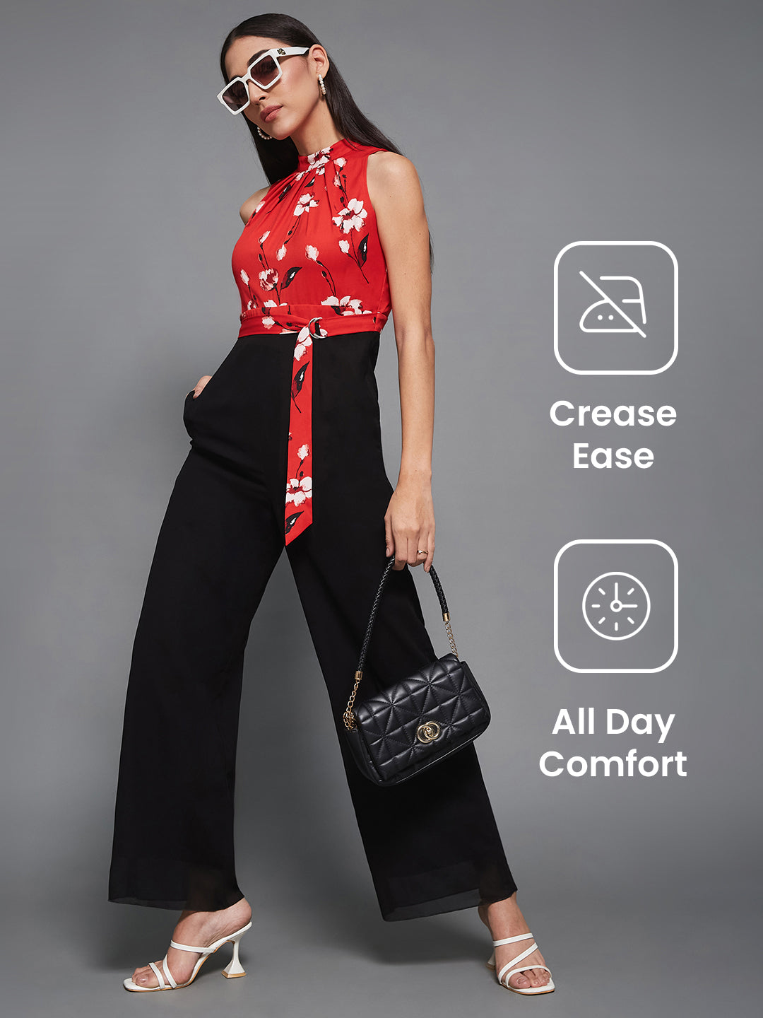 Women's Red & Black Georgette Floral Regular Halter Jumpsuit. Has floral pattern and zip closure.