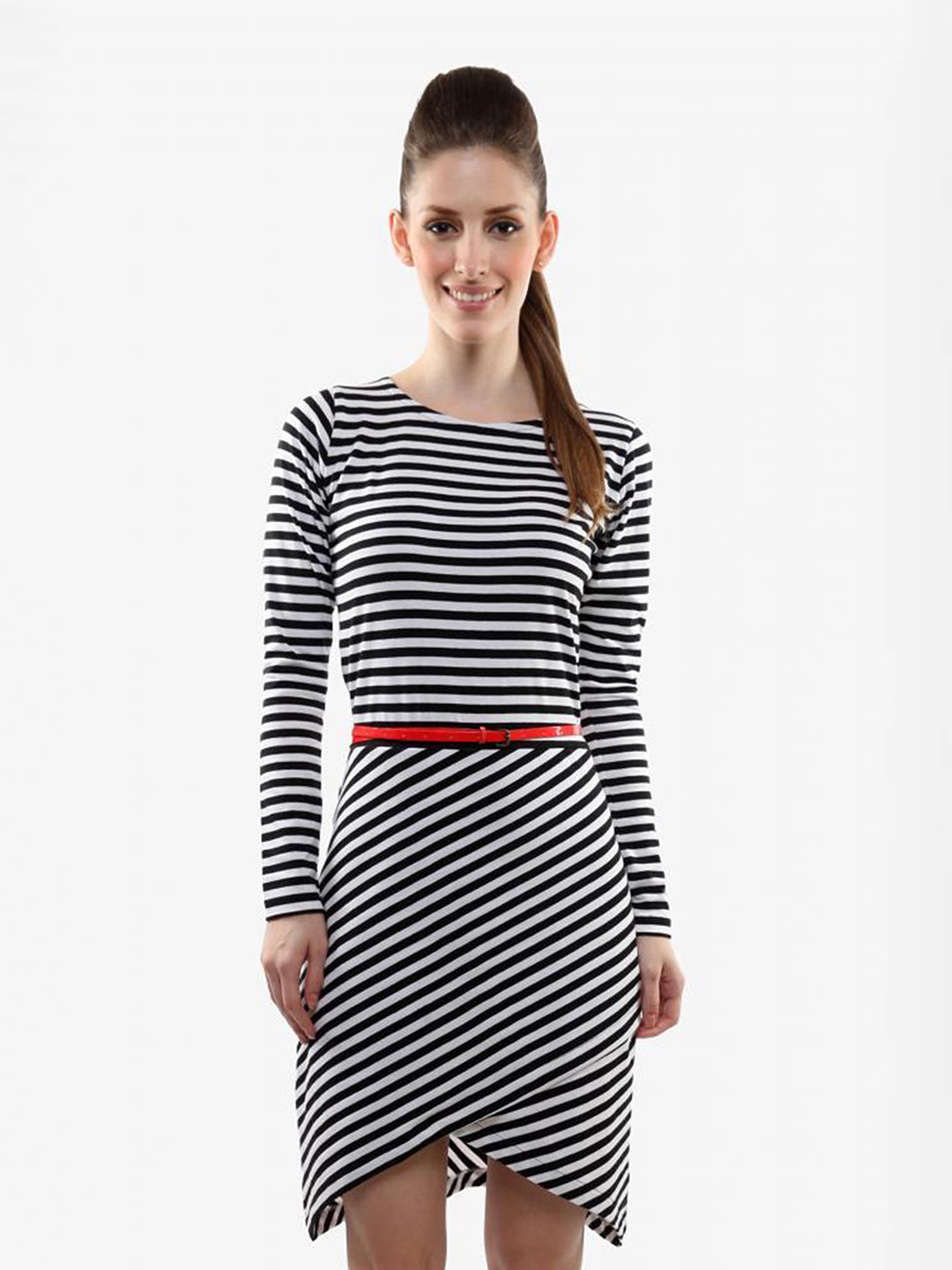 Woman wearing a black and white striped dress with a red belt on a white background
