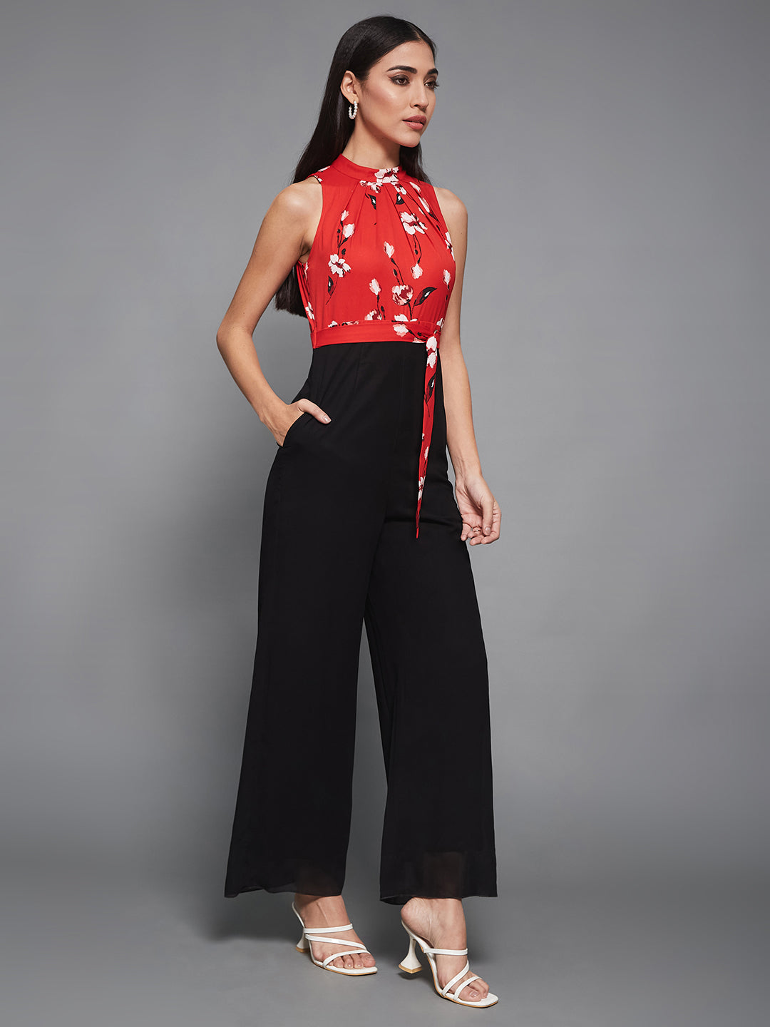 Women's Red & Black Georgette Floral Regular Halter Jumpsuit. Has floral pattern and zip closure.