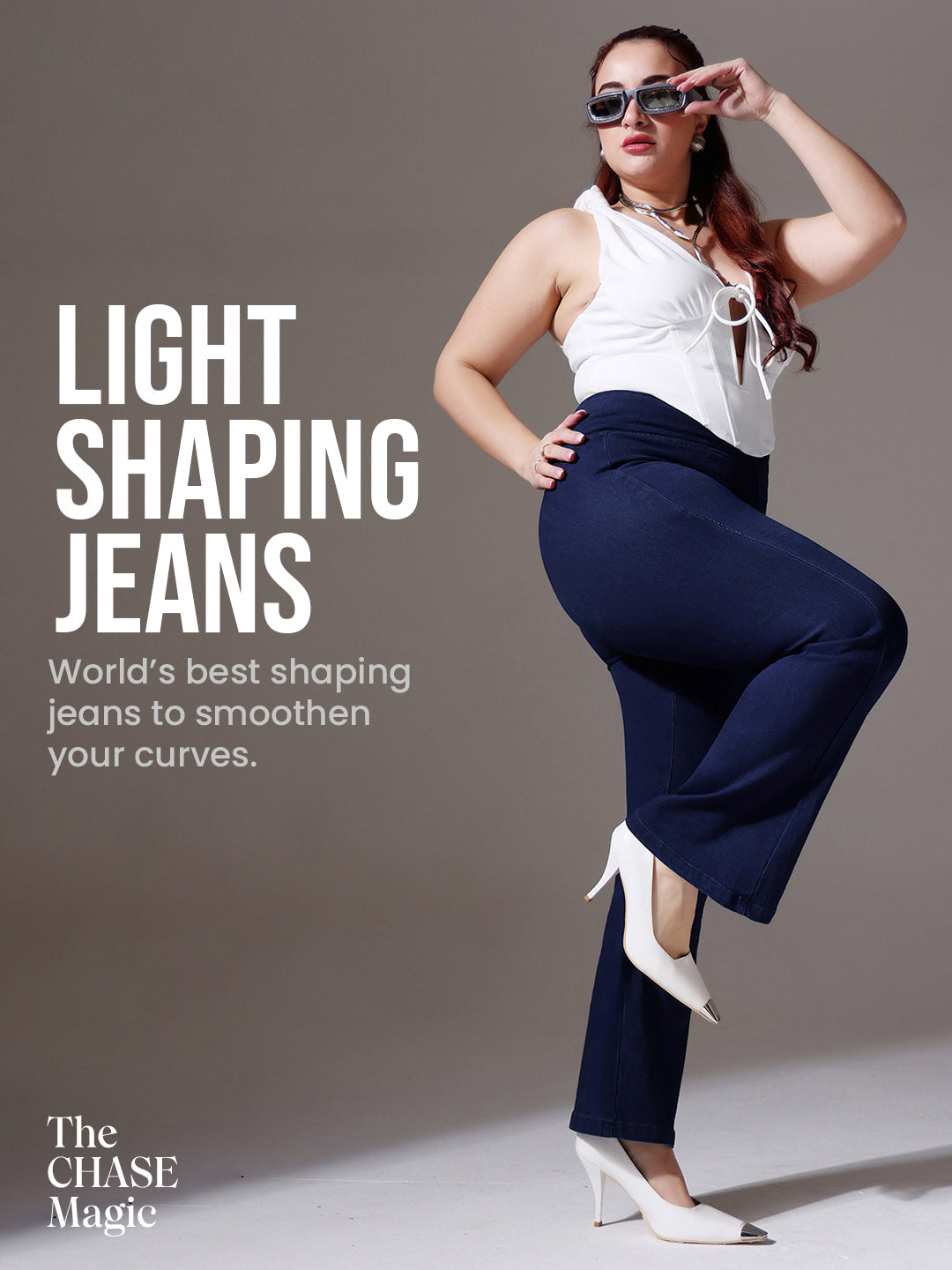 Mid-sized woman wearing a pair of Bootcut High-Rise Navy Blue Denim Jeans which provides light tummy smoothening with the patented CHASEshapeTM Panel