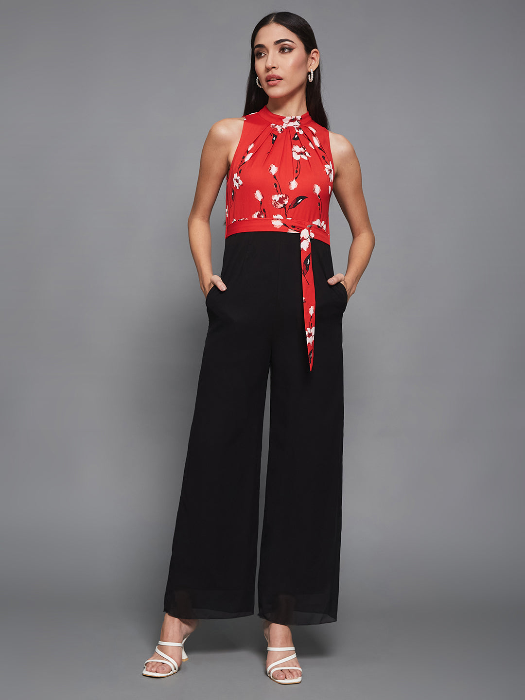Women's Red & Black Georgette Floral Regular Halter Jumpsuit. Has floral pattern and zip closure.