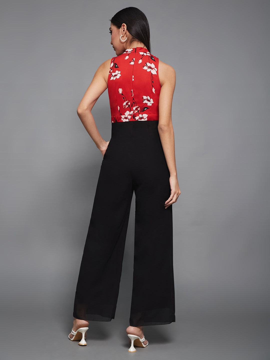 Women's Red & Black Georgette Floral Regular  Halter Jumpsuit. Has floral pattern and zip closure.