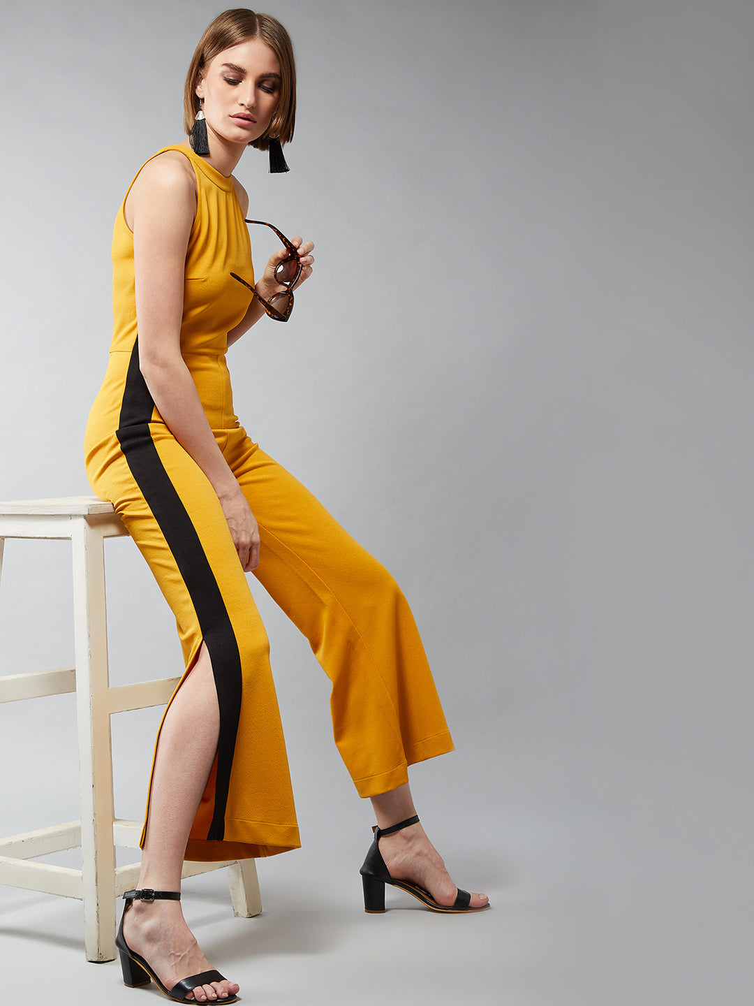 Women's Mustard Yellow & Black Halter Neck Sleeveless Solid Flared Jumpsuit